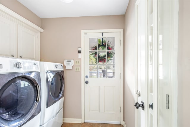 clothes washing area with cabinets, independent washer and dryer, and light tile patterned flooring