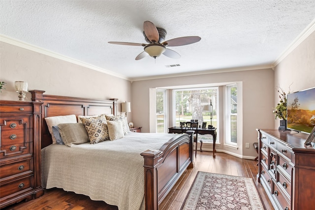 bedroom with ornamental molding, dark wood-type flooring, a textured ceiling, and ceiling fan