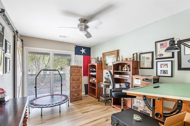 office area with light hardwood / wood-style floors and ceiling fan