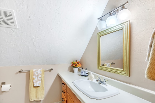 bathroom with vanity and vaulted ceiling