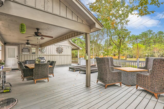 wooden terrace with area for grilling and ceiling fan