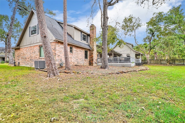 back of property featuring a yard, a wooden deck, and central AC unit