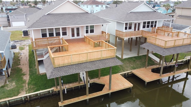 back of house featuring a deck with water view