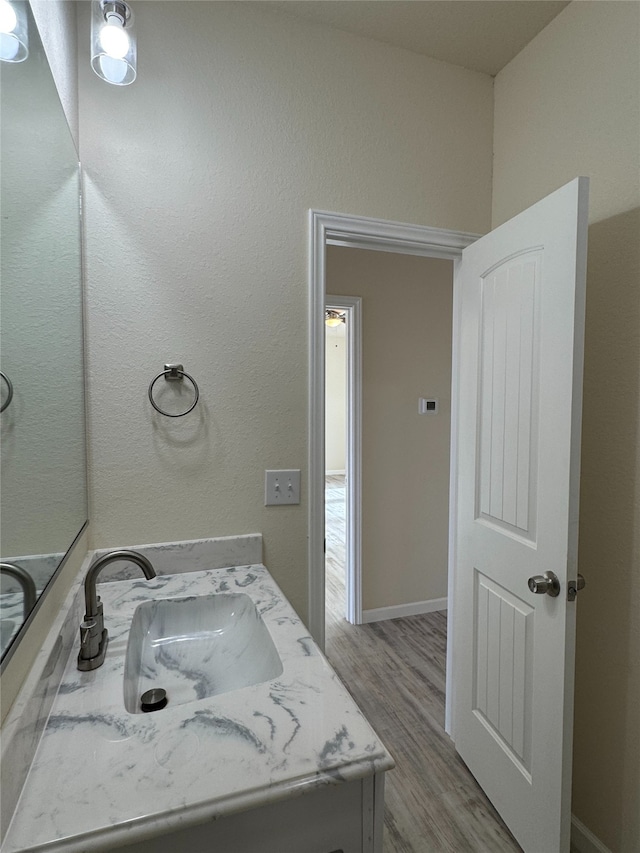 bathroom with hardwood / wood-style flooring and vanity