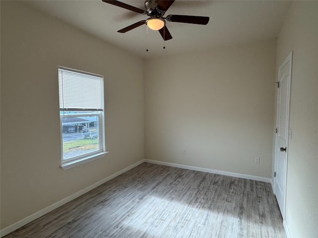 spare room with ceiling fan and light hardwood / wood-style flooring