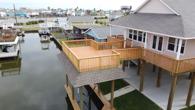 dock area with a water view and a patio