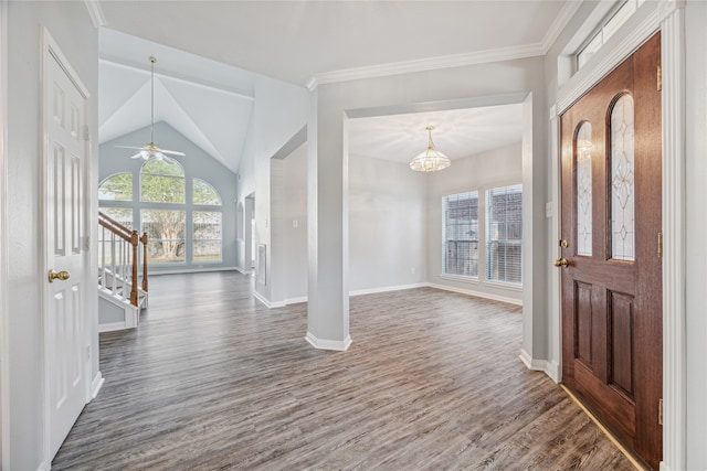 foyer entrance featuring ornamental molding, dark wood-type flooring, ceiling fan, and lofted ceiling