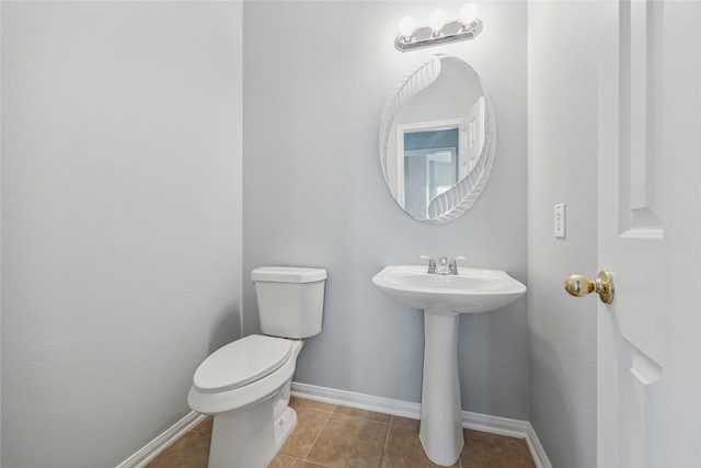 bathroom featuring tile patterned flooring, sink, and toilet