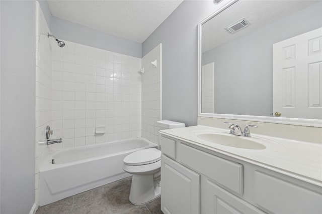 full bathroom featuring tiled shower / bath combo, vanity, and toilet