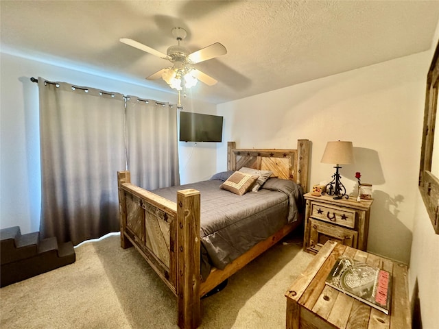 bedroom featuring a textured ceiling, carpet flooring, and ceiling fan