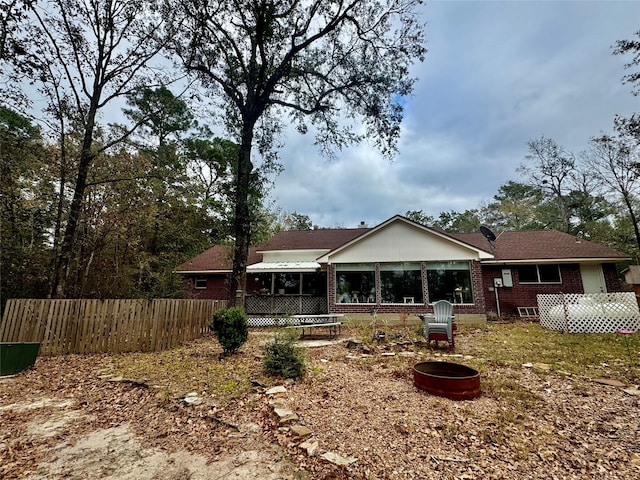 back of house with a fire pit