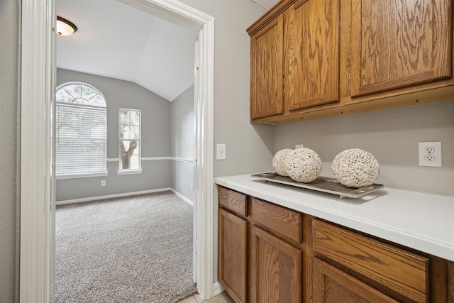 interior space featuring lofted ceiling and light colored carpet