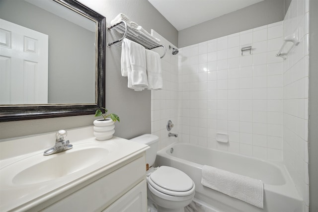 full bathroom featuring vanity, tiled shower / bath combo, and toilet