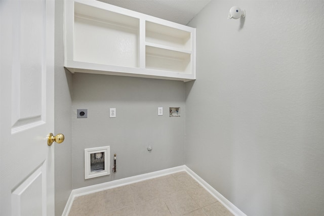 washroom featuring gas dryer hookup, hookup for a washing machine, light tile patterned floors, and electric dryer hookup