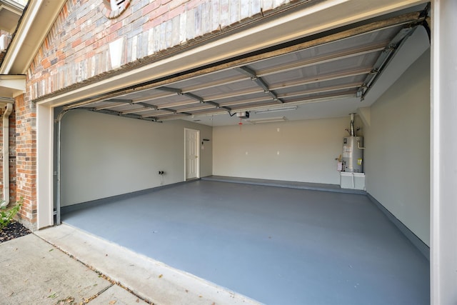 garage with a garage door opener and water heater