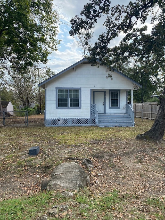 bungalow-style home featuring fence