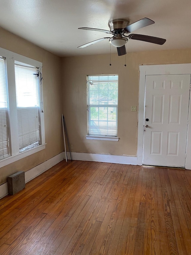 entrance foyer featuring baseboards and wood finished floors