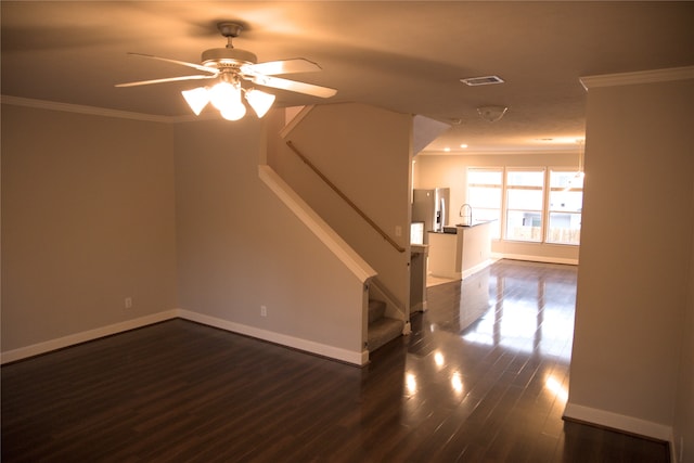 unfurnished living room featuring dark hardwood / wood-style flooring, ceiling fan, ornamental molding, and sink