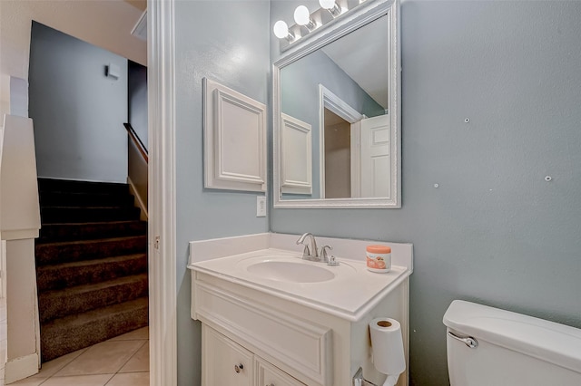 bathroom featuring vanity, toilet, and tile patterned flooring