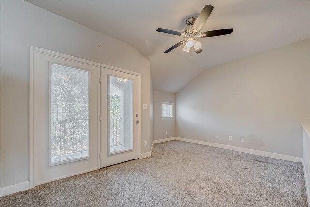 interior space with ceiling fan, light colored carpet, and lofted ceiling