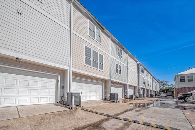 exterior space featuring a garage and central AC