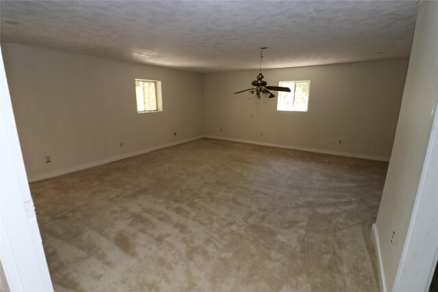 20 Ranchero Rd, College Station, TX 77845 - carpeted empty room with a textured ceiling, a healthy amount of sunlight, and ceiling fan