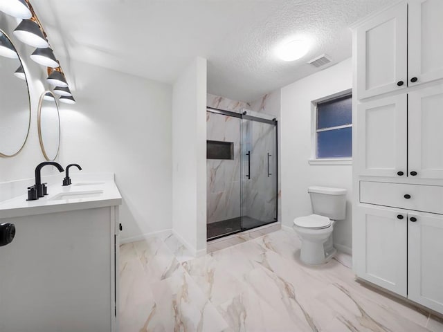 full bathroom with toilet, marble finish floor, a textured ceiling, a marble finish shower, and vanity