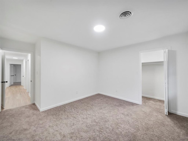 unfurnished bedroom featuring carpet and a closet