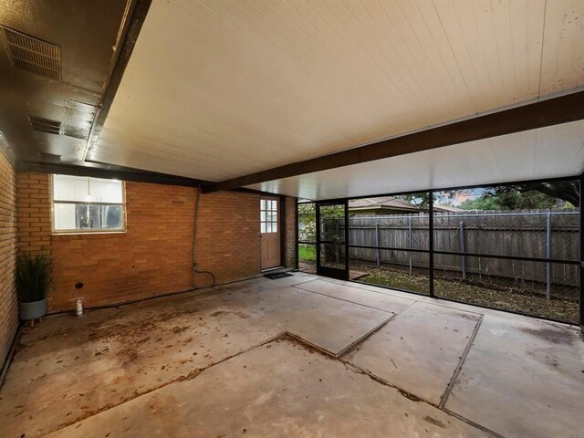 view of patio with visible vents and fence