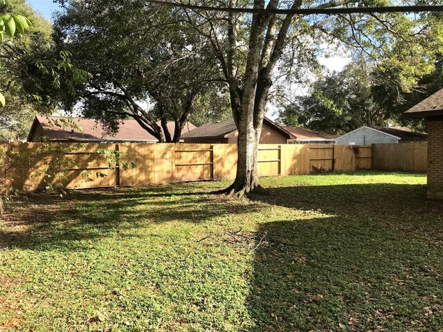 view of yard with a fenced backyard