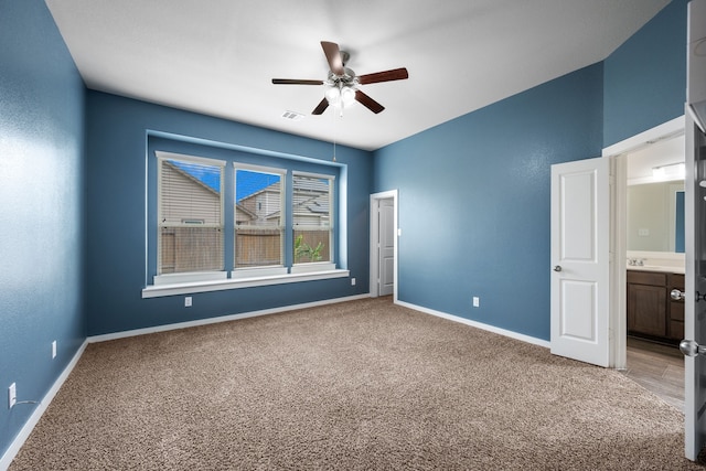 interior space with carpet flooring and ceiling fan