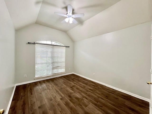 unfurnished room featuring vaulted ceiling, dark hardwood / wood-style floors, and ceiling fan