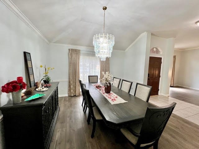 dining room featuring ornamental molding, a chandelier, and light hardwood / wood-style floors