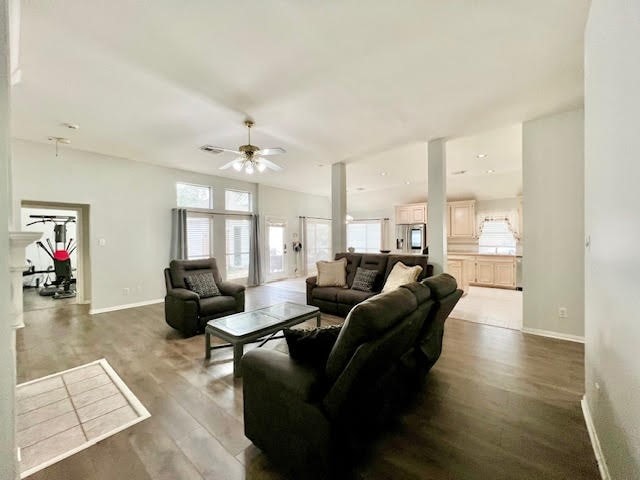 living room featuring ceiling fan and wood-type flooring