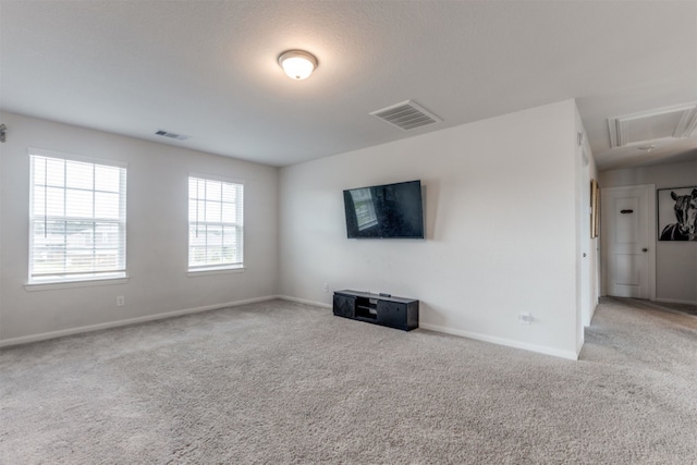 unfurnished living room featuring light colored carpet