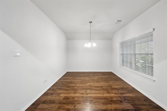 unfurnished dining area with vaulted ceiling, an inviting chandelier, and dark hardwood / wood-style floors