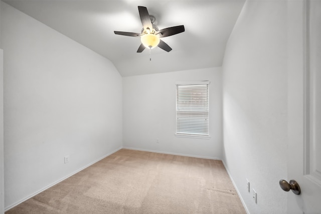 carpeted spare room with lofted ceiling and ceiling fan