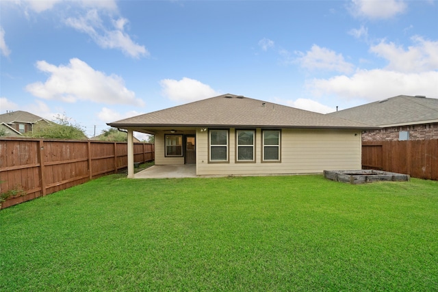 back of property with a yard and a patio