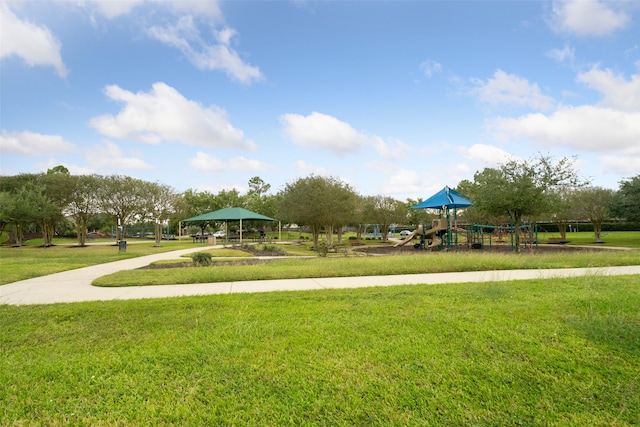 view of property's community with a gazebo, a playground, and a lawn