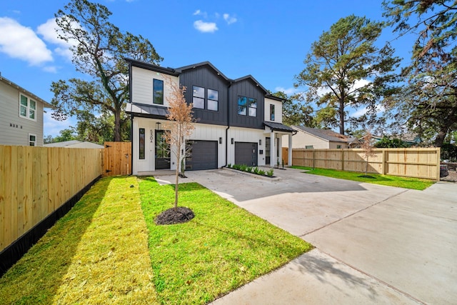 view of front of house with a garage and a front lawn