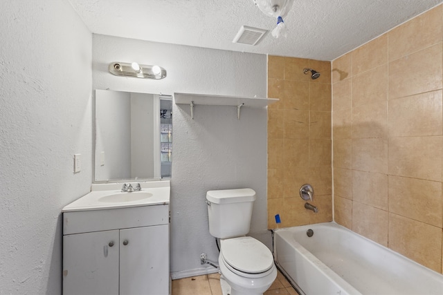 full bathroom featuring tile patterned flooring, tiled shower / bath, a textured ceiling, vanity, and toilet