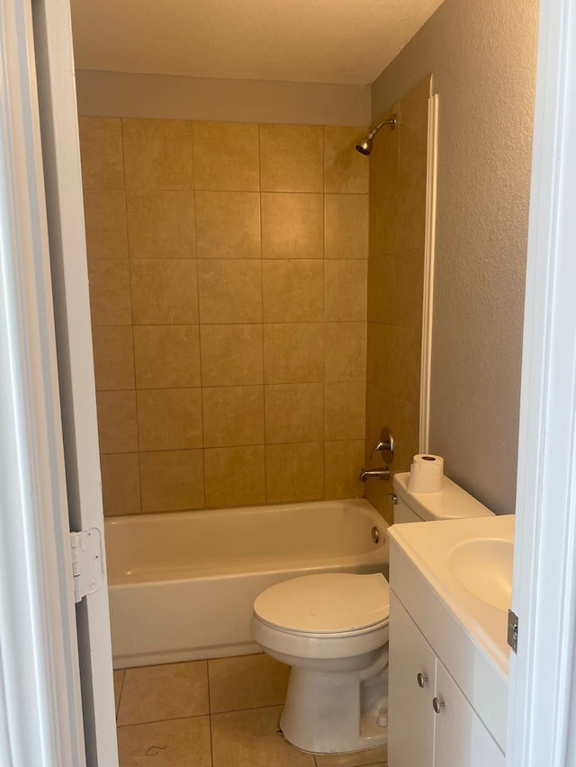 full bathroom with toilet, vanity, tiled shower / bath, and tile patterned floors