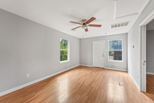 unfurnished room with plenty of natural light, light hardwood / wood-style floors, and ceiling fan