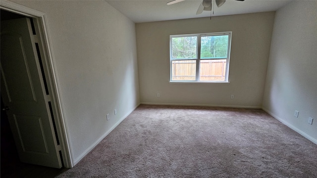 carpeted spare room featuring ceiling fan