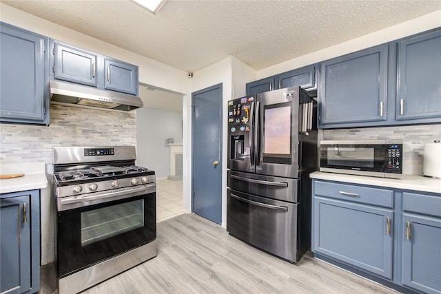 kitchen with stainless steel appliances, decorative backsplash, light hardwood / wood-style flooring, and blue cabinets