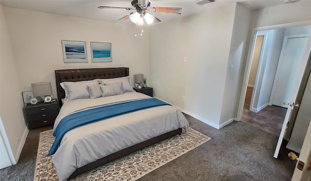 bedroom featuring ceiling fan and dark colored carpet