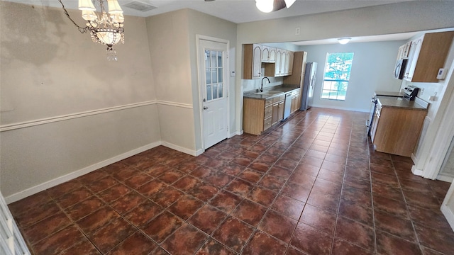 kitchen with a notable chandelier, appliances with stainless steel finishes, and sink