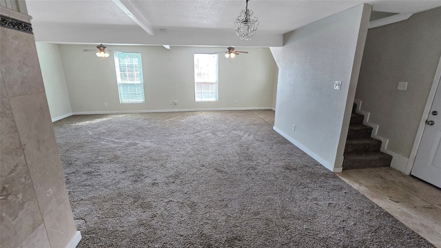 carpeted empty room featuring beam ceiling and a textured ceiling