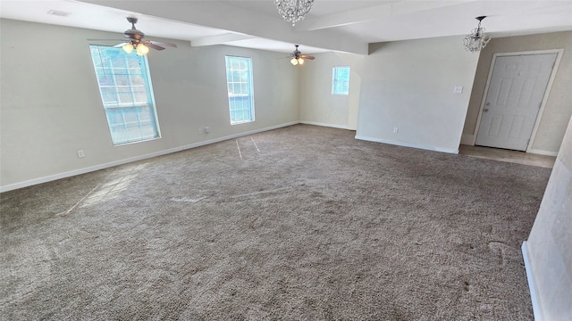 spare room featuring beamed ceiling, carpet floors, and ceiling fan with notable chandelier