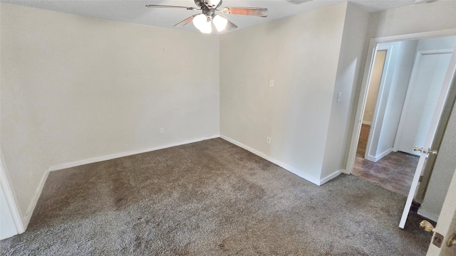 unfurnished room featuring dark colored carpet and ceiling fan